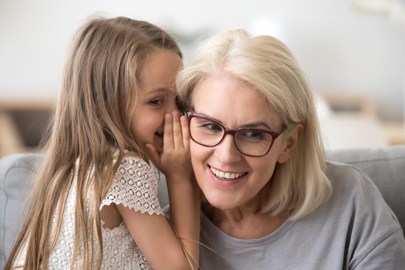 Otosclerosis-symptoms Grandmother listening to grandchild speak after being treated for otosclerosis