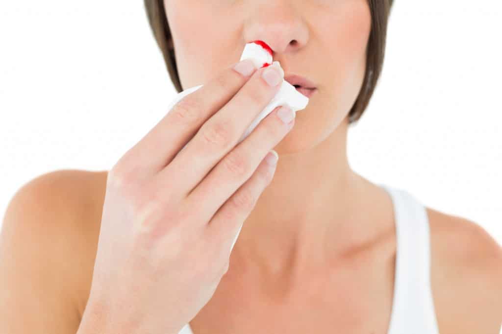 an ent patient uses a tissue for their nosebleed